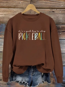 Brown crewneck sweatshirt featuring colorful 'it's a good day to play PICKLEBALL' text print