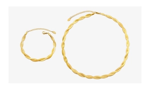 Detail of twisted 18k gold plated choker and bracelet set with snake chain texture