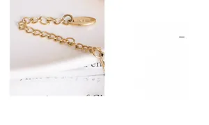 Detailed macro view of the 18K gold plated extension chain and K18 hallmark tag