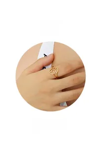 Artistic gold-plated abstract wire-wrapped face ring in a minimalist creative design
