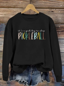 Detail of its a good day to play pickleball print on black crewneck sweatshirt