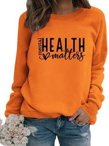 Detail of orange long-sleeve sweatshirt with black Mental Health Matters print