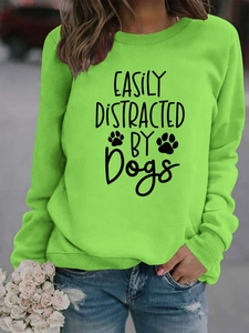 Detail of green hoodie with Easily Distracted by Dogs print and ribbed neck detail