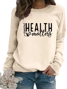 Detail of apricot crewneck sweatshirt with mental health matters print and ribbed cuffs