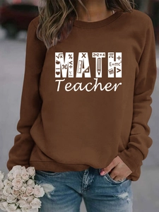 Close-up of brown Math Teacher sweatshirt with white math formulas and artistic icons