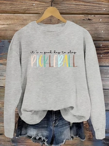 Detail of grey crewneck sweatshirt with 'it's a good day to play PICKLEBALL' print