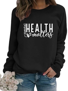 Detailed close-up of 'mental HEALTH matters' white print on a black crewneck sweatshirt