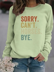 Détails des poignets et de l'ourlet côtelés sur ce sweat-shirt graphique vert clair