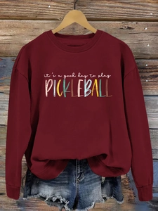 Detail of burgundy crewneck sweatshirt with 'it's a good day to play pickleball' print