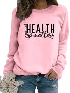 Detail of pink crewneck sweatshirt featuring mental health matters print and soft fabric