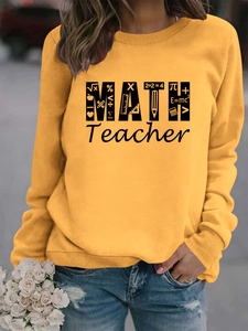 Detail of ginger yellow sweatshirt with MATH Teacher graphic and mathematical symbols