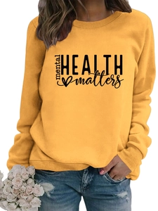 Detail of yellow mental health matters sweatshirt with heart print and ribbed cuffs