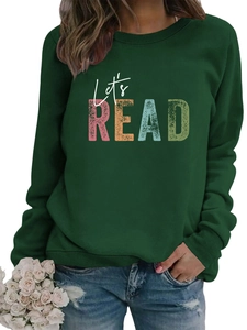 Close-up of dark green Let's READ print sweatshirt paired with casual distressed jeans