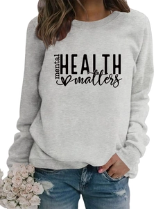 Detailed close-up of light grey crewneck sweatshirt with 'mental HEALTH matters' print