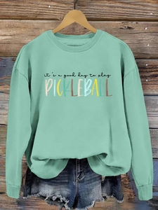 Detail view of mint green sweatshirt with its a good day to play pickleball print