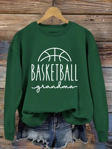 Detail of dark green basketball grandma sweatshirt with denim shorts on wooden background