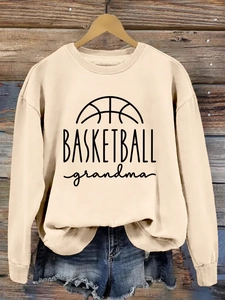 Detail of light beige crewneck sweatshirt with black BASKETBALL grandma print and graphics