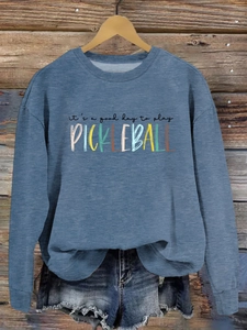 Detail of blue pickleball crewneck sweatshirt with 'it's a good day' colorful print