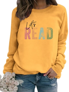 Detail of a ginger yellow long sleeve sweatshirt with colorful Let's READ graphic print