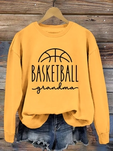 Detail of BASKETBALL grandma print on ginger yellow crewneck sweatshirt and denim shorts