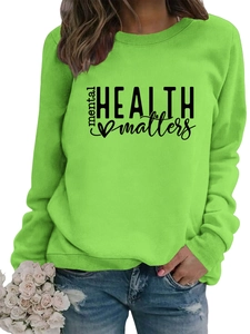 Detail of bright green crewneck sweatshirt with black mental health matters printed text