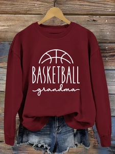 Detail of burgundy basketball grandma sweatshirt showing knit texture and graphic print
