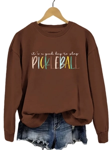 Detail view of coffee brown sweatshirt with colorful pickleball slogan print