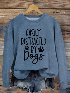 Detail of blue pullover sweatshirt featuring black Easily Distracted By Dogs print design