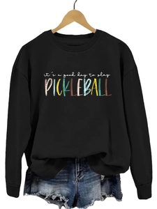 Close-up of it's a good day to play pickleball artistic print on black sweatshirt