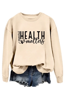 Detail of mental health matters print on cream long sleeve crewneck sweatshirt for women