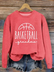 Detail of red crewneck sweatshirt with white basketball grandma print on wood background