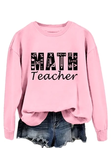 Detail of bright pink crewneck sweatshirt with MATH Teacher graphic and math symbols