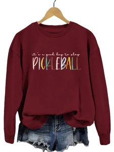 Detail of the high-quality print on burgundy sweatshirt showing pickleball theme design