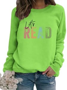 Detailed close-up of Let's READ colorful print on a bright green crewneck sweatshirt