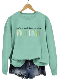 Detail of mint green sweatshirt with 'it's a good day to play PICKLEBALL' text print