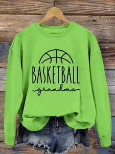 Detail of neon green crewneck sweatshirt featuring black BASKETBALL grandma print
