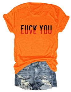 Detail view of orange cotton t-shirt with creative print and distressed denim shorts