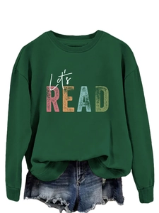 Close-up of vintage Let's READ print on dark green crewneck sweatshirt with distressed detail