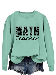 Close-up of mint green math teacher sweatshirt featuring black mathematical formulas and symbols