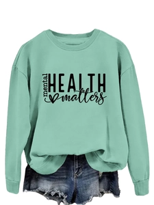 Detail of mint green sweatshirt with Mental Health Matters print and heart graphic