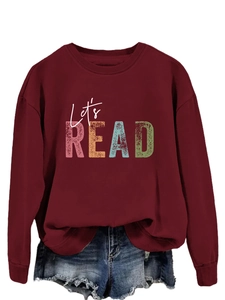 Detail of Let's READ print on a burgundy sweatshirt with ribbed cuffs and neck