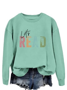 Detail of mint green sweatshirt with Let's READ print and raw hem denim shorts