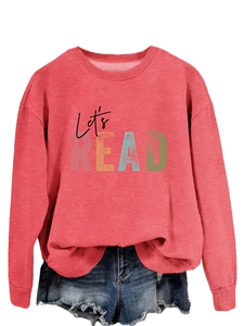 Close-up of brick red crewneck sweatshirt featuring Let's READ artistic letter print