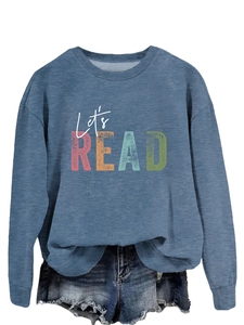 Detailed close-up of the vintage 'Let's READ' print on this blue crewneck sweatshirt