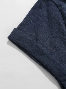Detail van de opgerolde mouw op een donkerblauw gebreid T-shirt met V-hals