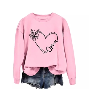 Pink crewneck sweatshirt with heart flower print and Oma text paired with denim shorts