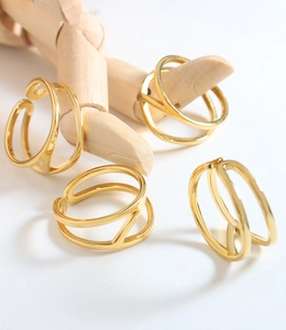 Detail of four-piece minimalist gold geometric open rings displayed on a wooden hand model