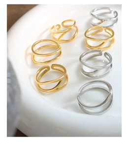 Detail view of seven minimalist hollow-line open rings in gold and silver finish