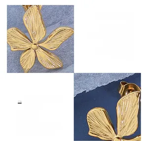 Macro shot of 18K gold plated stainless steel earrings with textured flower petal design