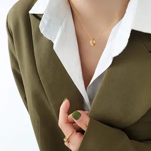 Minimalist 18K gold plated necklace with round pendant and matching wrap ring on model